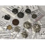 A collection of coins including an 1870's Spanish Peseta, a George III farthing, etc.