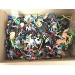 A box containing a collection of plastic cowboys a