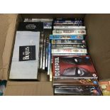 A collection of DVDs and VHS tapes including a 'Ca