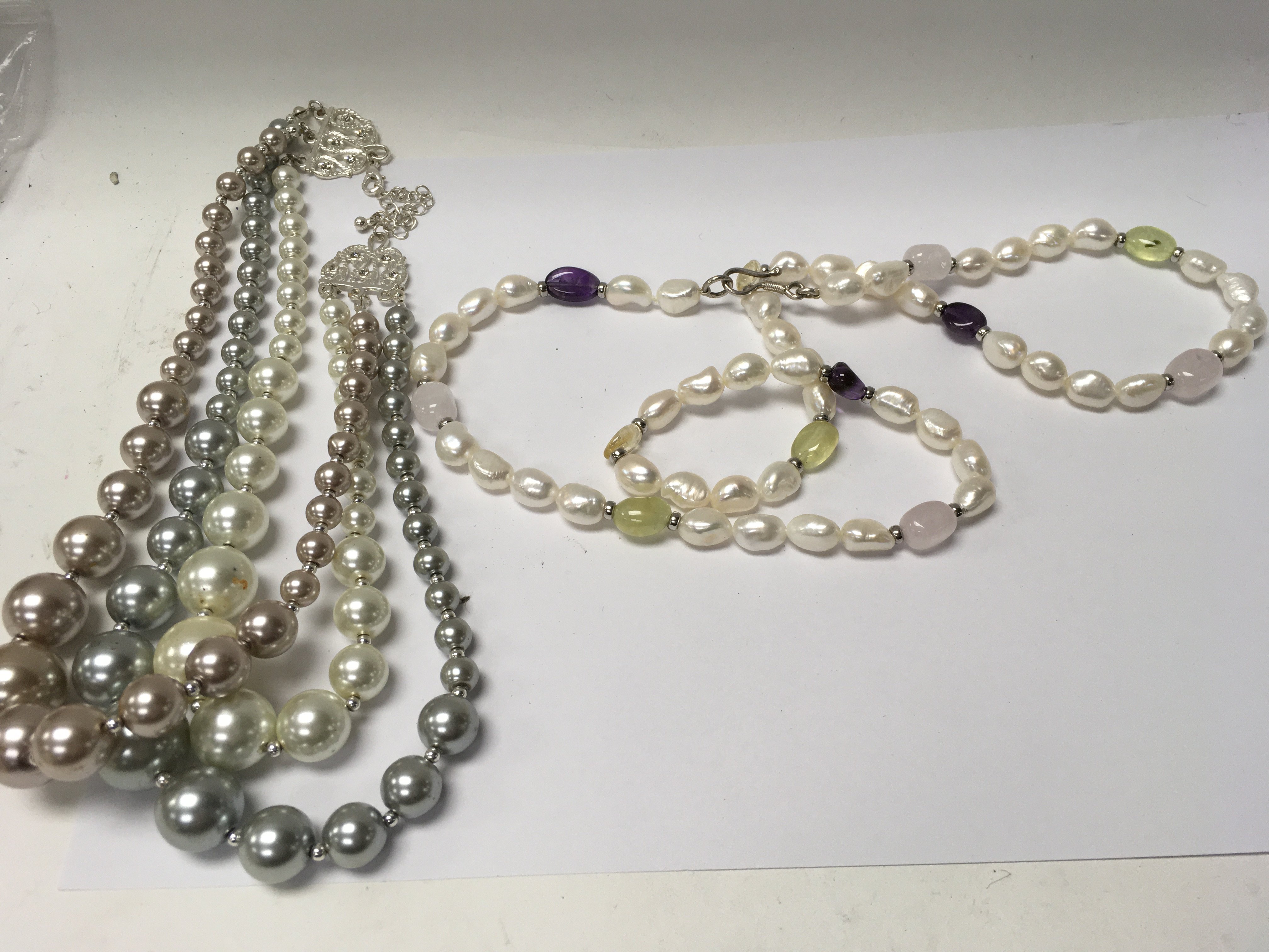 Two decorative costume pearl costume necklaces.
