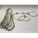 Two decorative costume pearl costume necklaces.