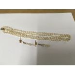 A Pearl necklace with a 9ct gold clasp and matchin