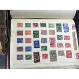 A box containing cigarette cards stamp albums and