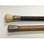 A Victorian ebony and ivory walking cane with silv