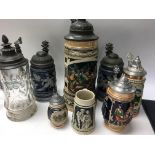 A collection of eight German beer steins.