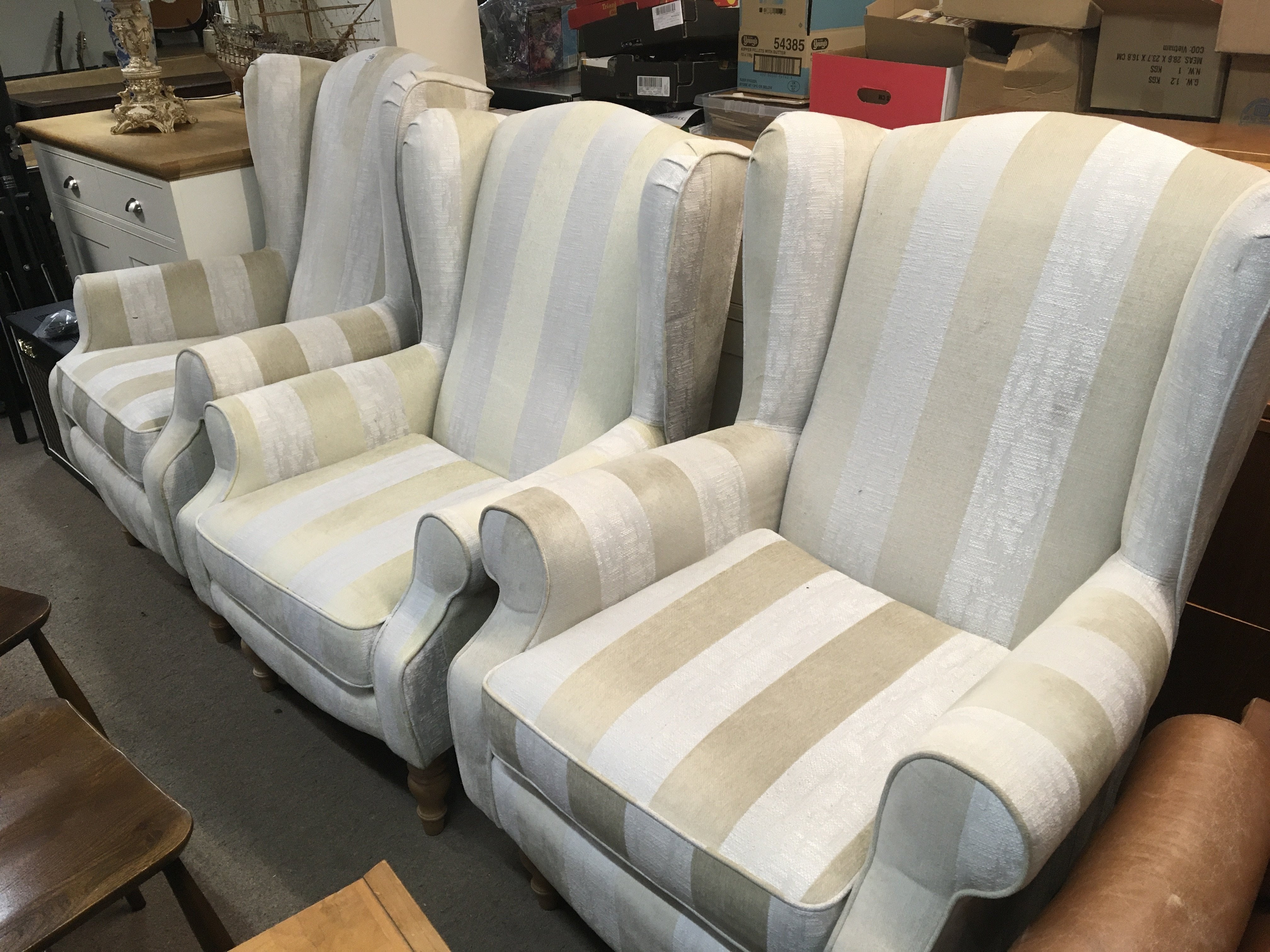 Two modern HSL arm chairs upholstered in a light cream wide striped fabric.