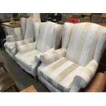 Two modern HSL arm chairs upholstered in a light cream wide striped fabric.