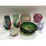 A collection of coloured glass items comprising a