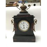 A black slate mantel clock with gilt metal mounts.