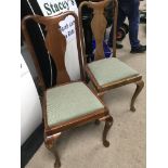 A pair of mahogany dining chairs with drop in seat