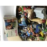A box containing Disney caricature ornaments a mat