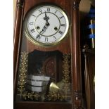 Two wall clocks consisting of a mahogany clock having circular dial with Roman numerals and