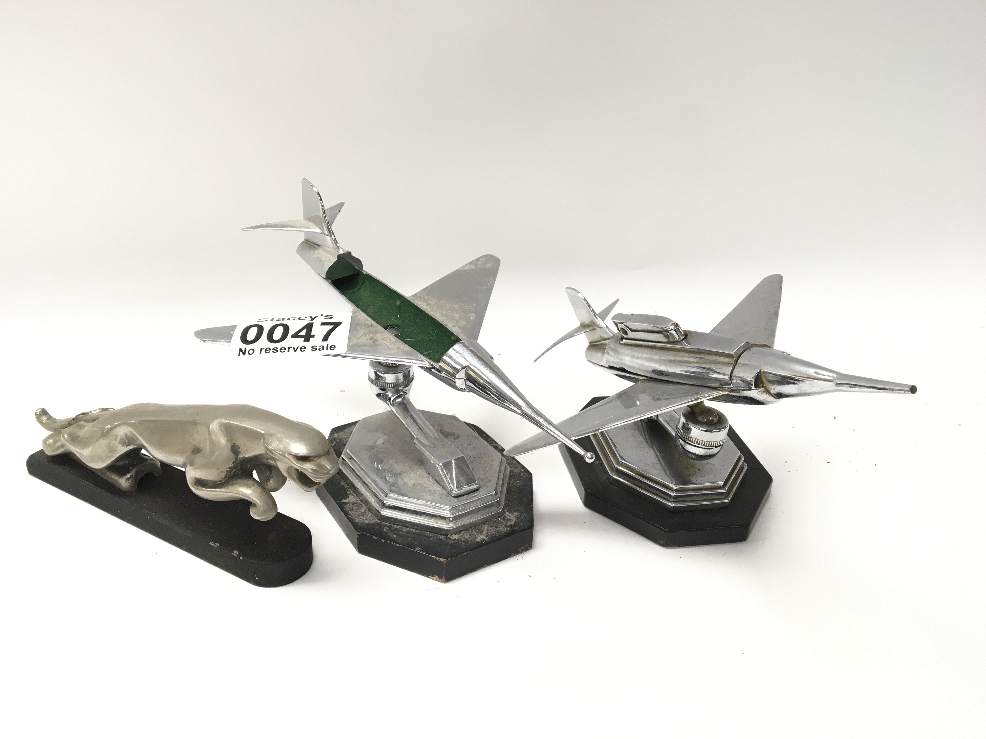 Two vintage chrome jet airplane lighters and a Jag