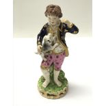 An early 18th century Derby porcelain figure of a boy and his dog. 15cm