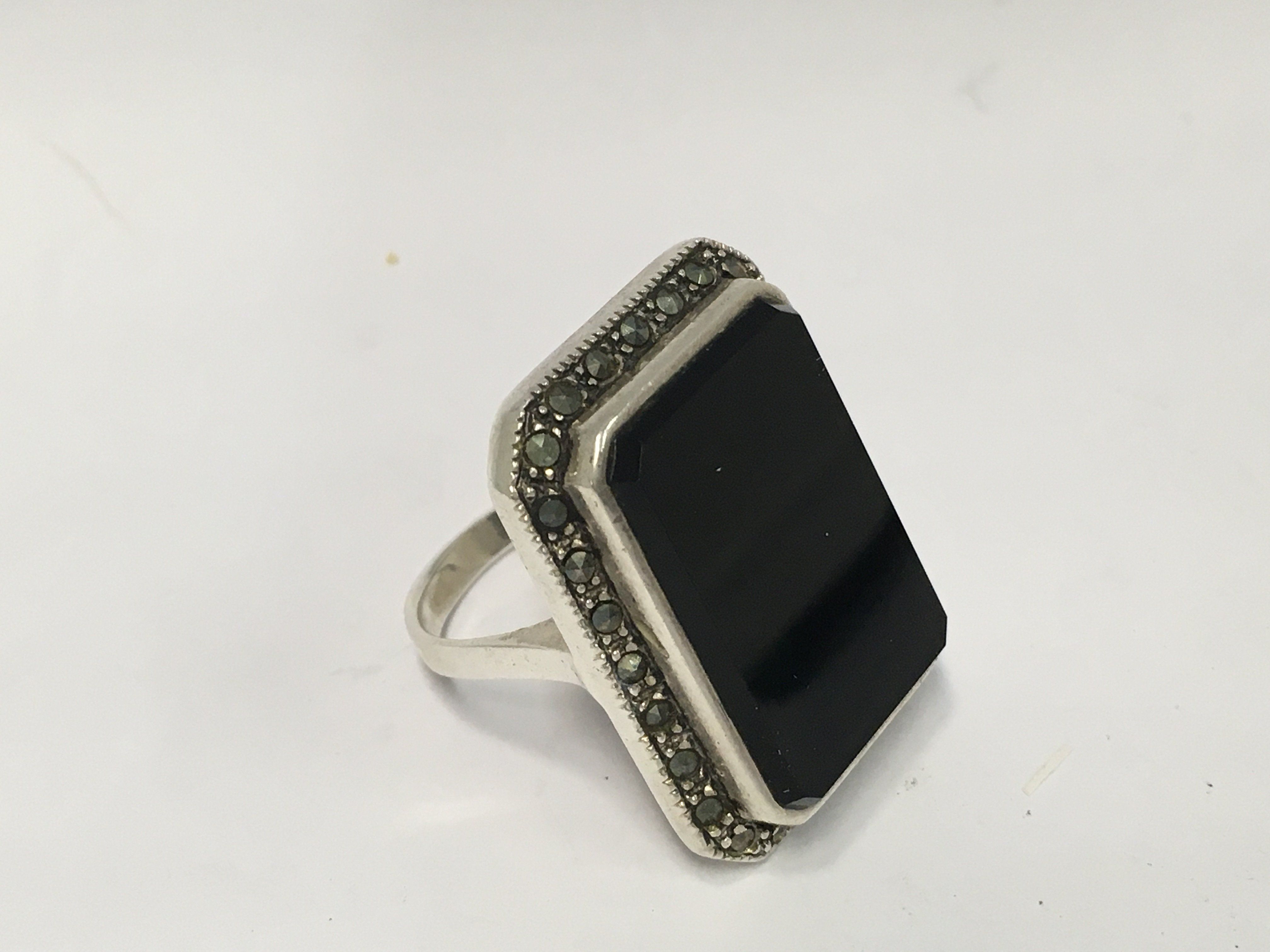 A large sterling silver onyx and marcasite ring.