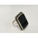 A large sterling silver onyx and marcasite ring.