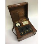 A vintage cased brass bound mahogany electric OHMS meter by Gambrell Brothers Ltd.