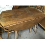 A Ercol drop leaf table together with five stick b