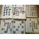 Four albums of GB and world stamps.