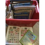 A box of various stamp albums and loose stamps.