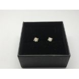 A pair of 18ct white gold four claw set RBC diamon