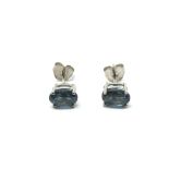 A pair of silver studs set with London blue topaz.