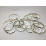 A collection of silver bracelets.