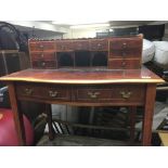 A 20th century desk fitted with small drawers.on s