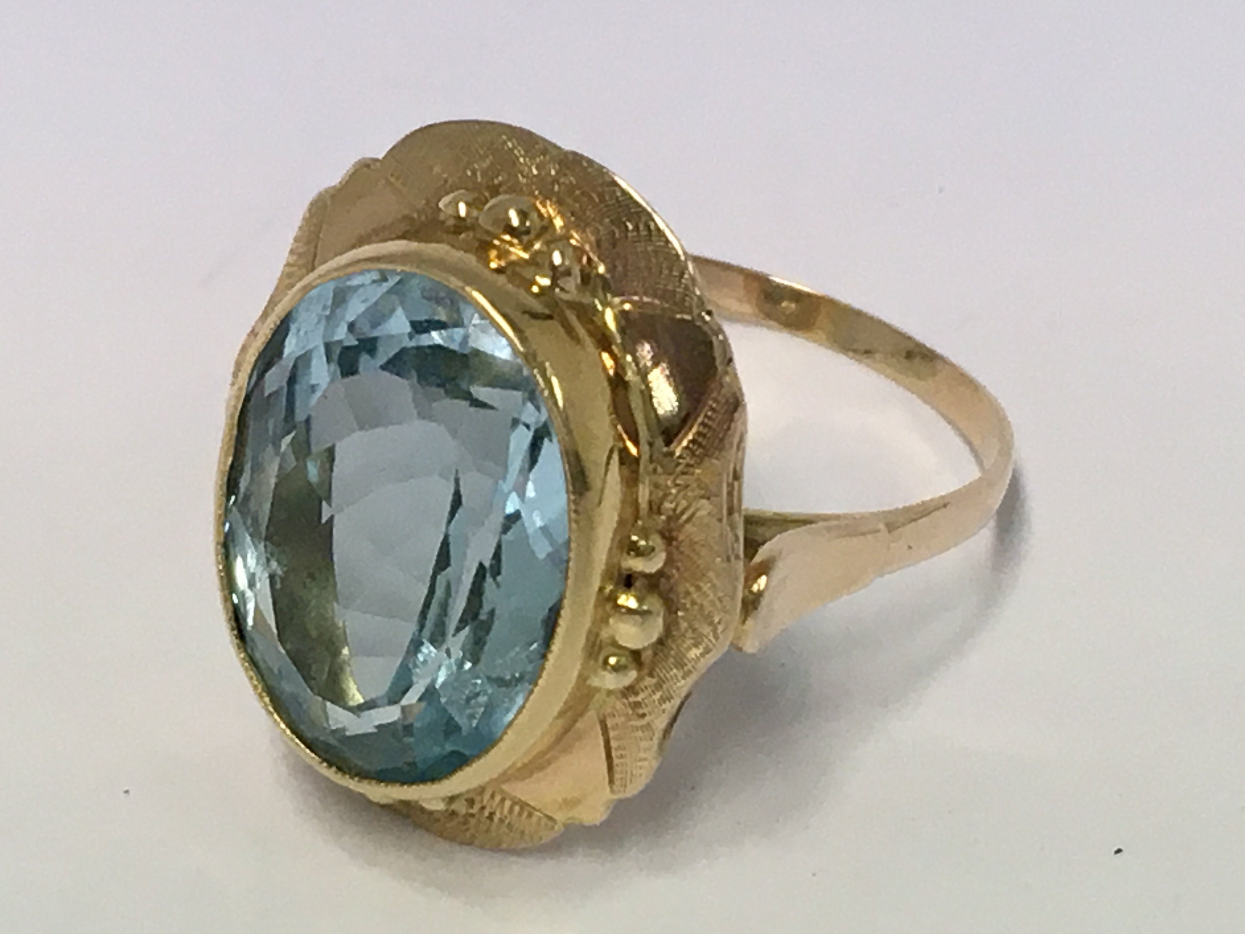 A fancy gold and large blue topaz set ring (unmark