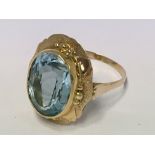 A fancy gold and large blue topaz set ring (unmark