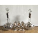 Two antique liqueur decanters with silver overlay