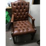 A leather upholstered button back office type open