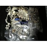 A box of diamonte jewellery items.