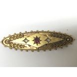 A vintage 15carat gold brooch set with ruby flanke