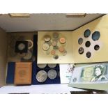 A box containing a collection of mixed commemorati