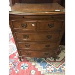 A walnut chest of drawers with brushing slide fitt