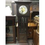 An oak framed 1930s grandfather clock with silvere
