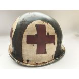 A WW2 US M1 Fixed Bale Medics helmet. Maker McCord