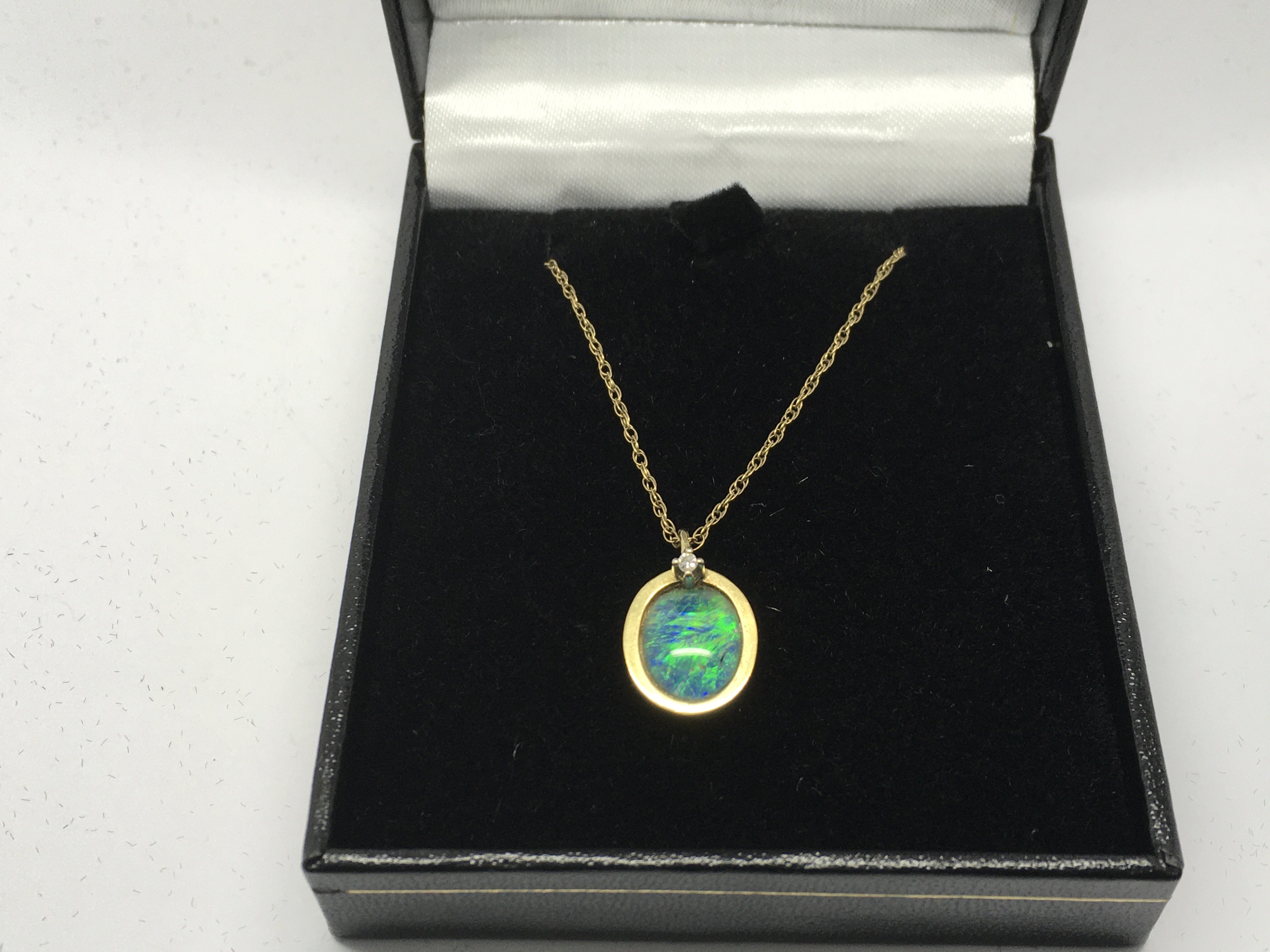 A 9ct gold pendant set with an opal doublet and a