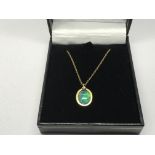 A 9ct gold pendant set with an opal doublet and a
