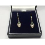 A boxed pair of drop earrings set with emeralds, p