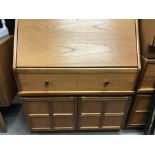 A Modern teak Nathan bureau, with draw and cupboar