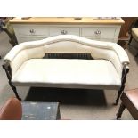 An Edwardian walnut sofa with white cream upholste