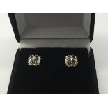 A pair of 9ct white gold earrings set with diamond