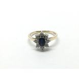 A 9ct gold oval cut sapphire and RBC diamond clust