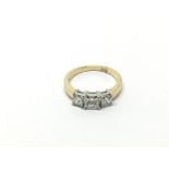 An 18ct yellow and white gold three stone princess