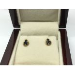 A pair of 9ct gold and sapphire earrings.