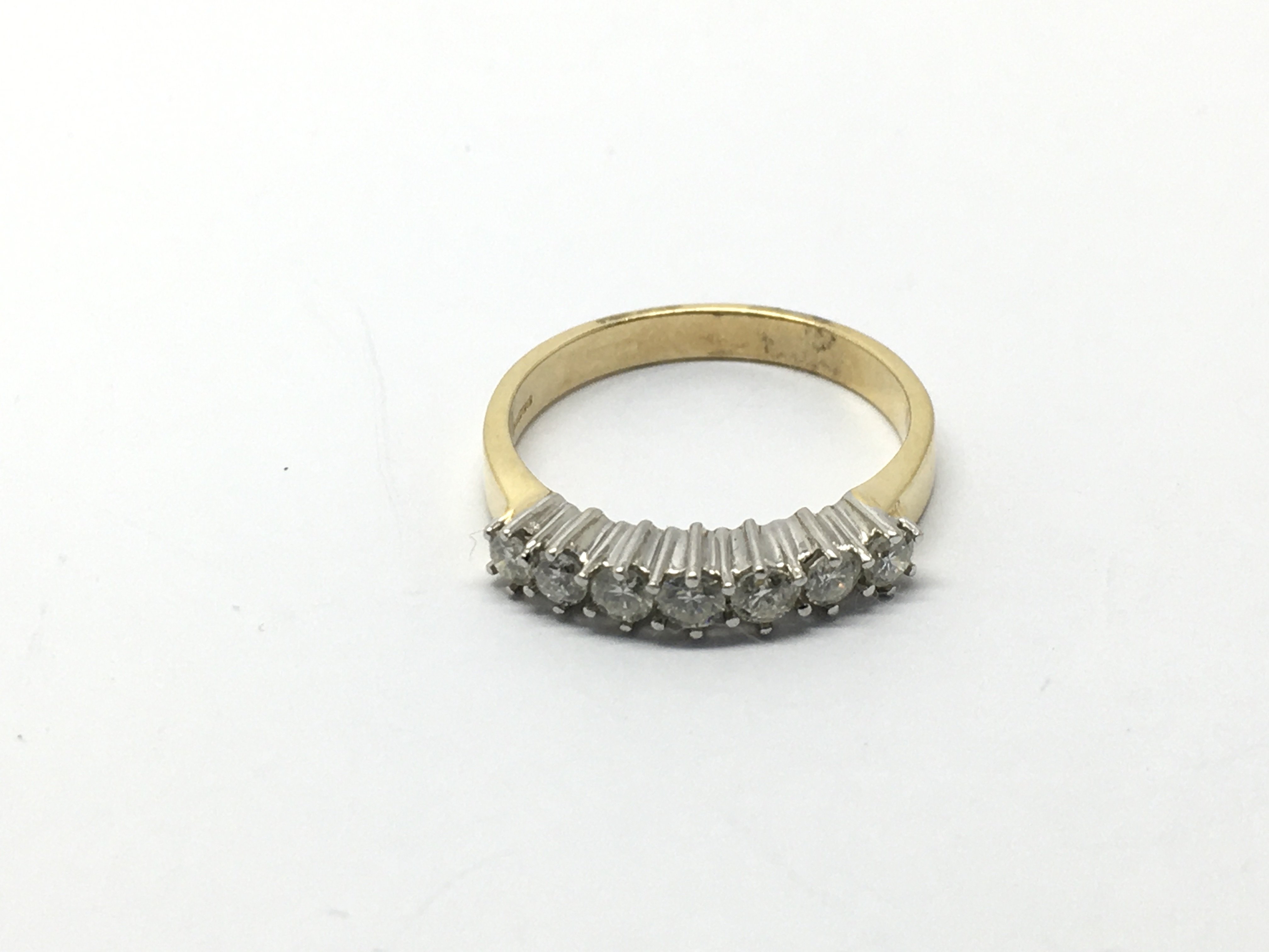 An 18ct gold seven stone diamond ring, diamonds ap