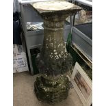 A weathered Neo classical garden pedestal with a s