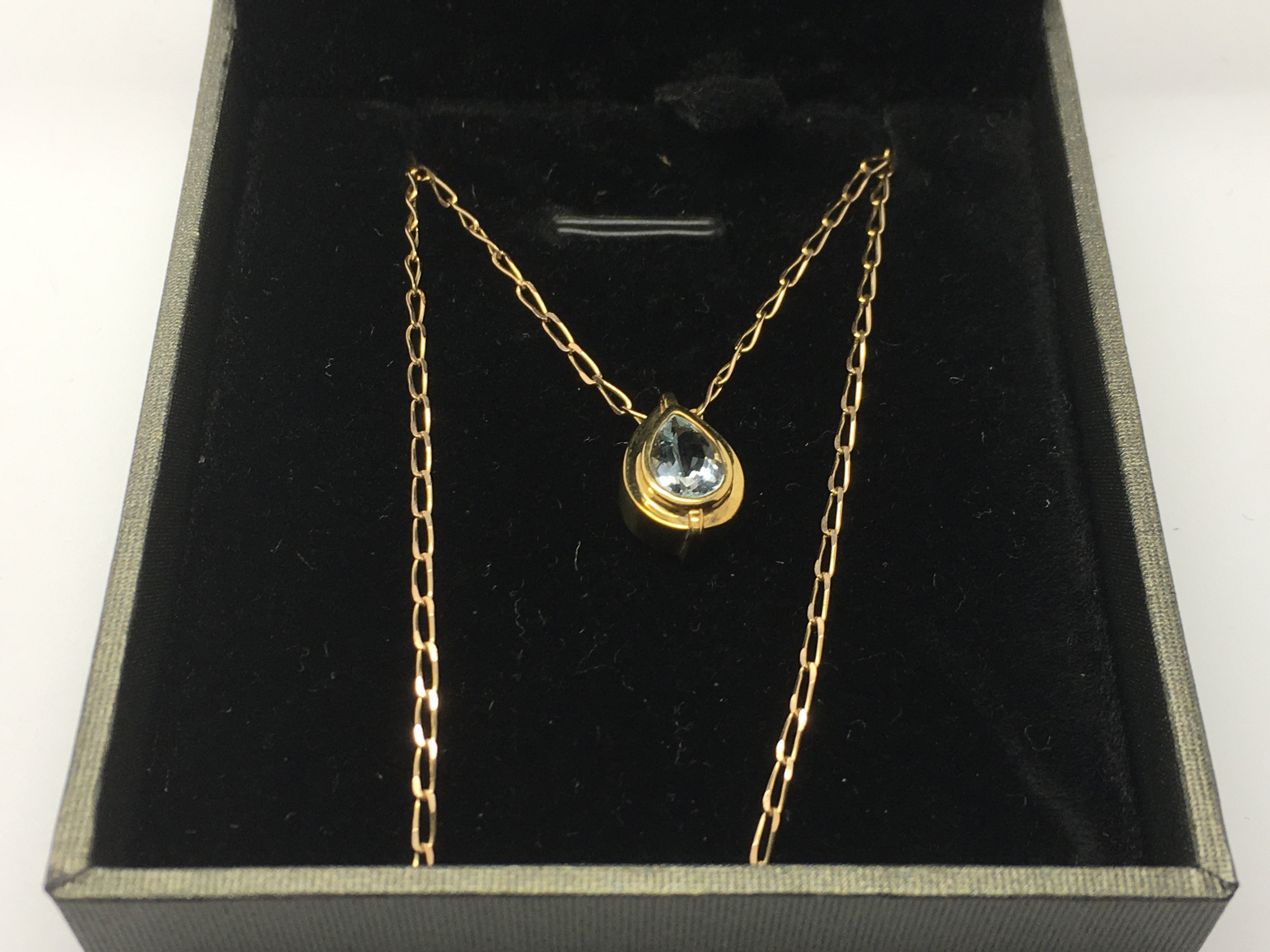 A 9ct gold and aquamarine set pendant and chain.